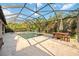 The screened pool features a dining area, a leafy view, and a lovely patio at 11092 58Th Street Cir E, Parrish, FL 34219