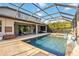 A screened in-ground pool with a hot tub and expansive outdoor lounging and dining areas at 11092 58Th Street Cir E, Parrish, FL 34219