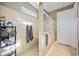 A tiled shower stall features glass doors and a transom window for natural light at 11092 58Th Street Cir E, Parrish, FL 34219