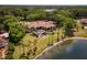 An aerial shot shows this home's luxurious outdoor amenities including a pool, fire pit, and lakeside access at 12224 Garden Lake Cir, Odessa, FL 33556