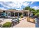 Lovely backyard patio with a bench, outdoor kitchen, and views of the pool and lush landscaping at 12224 Garden Lake Cir, Odessa, FL 33556