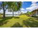 Expansive green backyard with lake views and palm trees, highlighting the property's outdoor space at 12224 Garden Lake Cir, Odessa, FL 33556