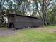 A barn-like structure featuring shade screening creating a functional space with ample storage and protection at 12224 Garden Lake Cir, Odessa, FL 33556