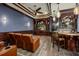 Basement area featuring a wet bar, custom lighting, and theater-style seating for ultimate comfort at 12224 Garden Lake Cir, Odessa, FL 33556