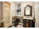 Elegant powder room with tiled shower and stylish vanity at 12224 Garden Lake Cir, Odessa, FL 33556