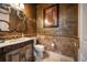 Stylish bathroom with a decorative mirror, ornate vanity, and unique textured walls at 12224 Garden Lake Cir, Odessa, FL 33556