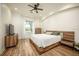Bright bedroom with a platform bed, hardwood floors, and natural light from the window at 12224 Garden Lake Cir, Odessa, FL 33556