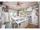 Spacious craft room with ample storage, craft supplies, and access to the outdoors at 12224 Garden Lake Cir, Odessa, FL 33556