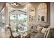 Elegant dining room boasts lake views through expansive windows, creating a serene and luxurious dining experience at 12224 Garden Lake Cir, Odessa, FL 33556
