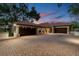 Elegant estate featuring a spacious driveway and expansive three-car garage at 12224 Garden Lake Cir, Odessa, FL 33556