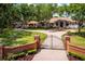 Stately home featuring a gated entrance, circular driveway, and lush landscaping, offering curb appeal and privacy at 12224 Garden Lake Cir, Odessa, FL 33556