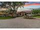 Circular driveway and fountain with a large estate home as the backdrop with gorgeous sunset at 12224 Garden Lake Cir, Odessa, FL 33556