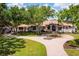 Beautiful home with lush trees, a circular driveway, and well-manicured lawn offering an inviting and serene setting at 12224 Garden Lake Cir, Odessa, FL 33556
