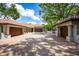 Spacious home exterior showcasing multiple garages and a wide driveway lined with trees and manicured landscaping at 12224 Garden Lake Cir, Odessa, FL 33556