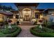 Stately home featuring meticulous landscaping, elegant columns, and a grand double door entrance at 12224 Garden Lake Cir, Odessa, FL 33556
