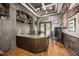 Sophisticated home office with hardwood floors, coffered ceilings, built in storage, and natural light at 12224 Garden Lake Cir, Odessa, FL 33556