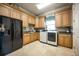 Large laundry room with front load washer/dryer, sink, granite countertops, and ample storage at 12224 Garden Lake Cir, Odessa, FL 33556