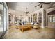 Spacious living room featuring a large sectional sofa and seamless access to outdoor patio at 12224 Garden Lake Cir, Odessa, FL 33556