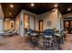 Elegant outdoor bar featuring stone accents, granite counters, and ornate seating with access to the patio at 12224 Garden Lake Cir, Odessa, FL 33556