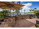 Outdoor kitchen featuring stone accents, stainless steel grill, and bar seating, perfect for lakeside entertaining at 12224 Garden Lake Cir, Odessa, FL 33556