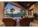 Elegant outdoor living space with pool, covered patio, and comfortable seating, perfect for relaxing and enjoying the sunset at 12224 Garden Lake Cir, Odessa, FL 33556