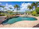 A stunning pool area with an outdoor grill, lakeside views, and ample lounge space for relaxation and entertainment at 12224 Garden Lake Cir, Odessa, FL 33556
