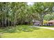 Expansive, well-manicured property with mature trees and landscaping, leading to the elegant residential home at 12224 Garden Lake Cir, Odessa, FL 33556
