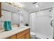 Bathroom featuring a walk-in shower and vanity sink, with a bright and clean design at 1235 Dockside Place # 108, Sarasota, FL 34242
