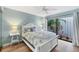 Cozy bedroom with a queen bed and serene outdoor views from sliding glass doors to the outside at 1235 Dockside Place # 108, Sarasota, FL 34242