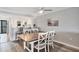 Bright dining area features a wooden table, seating for four, and a view into the modern kitchen at 1235 Dockside Place # 108, Sarasota, FL 34242
