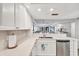 Bright kitchen features stainless steel appliances, a stylish sink, and elegant marble countertops for a modern look at 1235 Dockside Place # 108, Sarasota, FL 34242