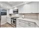 Modern kitchen with stainless steel appliances, white cabinets, and marble countertops for a sleek look at 1235 Dockside Place # 108, Sarasota, FL 34242