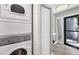 Convenient laundry room features a stacked washer and dryer in the main hall at 1235 Dockside Place # 108, Sarasota, FL 34242
