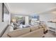 Bright living room boasts a comfy sectional, large windows, and elegant furnishings, offering serene views at 1235 Dockside Place # 108, Sarasota, FL 34242