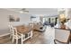Spacious living room with bright decor, wood floors and an open layout into the dining area at 1235 Dockside Place # 108, Sarasota, FL 34242