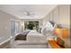 The main bedroom features a decorative accent wall, and a large window overlooking the yard at 1235 Dockside Place # 108, Sarasota, FL 34242