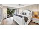 The main bedroom features a decorative accent wall, and a large window overlooking the yard at 1235 Dockside Place # 108, Sarasota, FL 34242