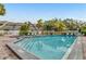 Outdoor pool area with steps, brick surround, lounge chairs and nearby condos at 1235 Dockside Place # 108, Sarasota, FL 34242