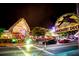 Night view of businesses along the street, including the Daiquiri Deck, with cars and people at 1235 Dockside Place # 108, Sarasota, FL 34242