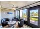Enclosed sun room with patio seating, ceiling fan, and lots of bright light at 1235 Dockside Place # 108, Sarasota, FL 34242