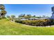 Lush lawn with manicured hedges offer water views in this desirable community at 1235 Dockside Place # 108, Sarasota, FL 34242