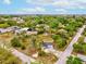 Aerial view of the house showcasing the spacious lot, nearby homes, and mature trees at 13241 Miami St, Hudson, FL 34667