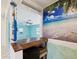Pass-through bar area with wood counter and beachy decor leading into a spacious living room at 13241 Miami St, Hudson, FL 34667