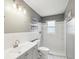 Neutral toned bathroom features a walk in shower with white subway tiles and floating shelves at 13241 Miami St, Hudson, FL 34667