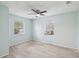 Bright bedroom with tile floors, ceiling fan, and natural light from windows at 13241 Miami St, Hudson, FL 34667