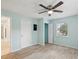 This bedroom has wood tile floors and light blue walls with a ceiling fan at 13241 Miami St, Hudson, FL 34667
