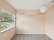 Neutral bonus room featuring a wall of windows, floating shelves, modern light fixture, and tile floors at 13241 Miami St, Hudson, FL 34667