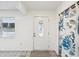 Bright entryway with tile floors, stylish rug, and decorative floral curtain at 13241 Miami St, Hudson, FL 34667