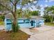 Exterior shot showcasing the blue siding of a single-story home with a covered entry at 13241 Miami St, Hudson, FL 34667