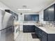 Modern kitchen with stainless steel appliances, blue cabinets, and decorative backsplash at 13241 Miami St, Hudson, FL 34667